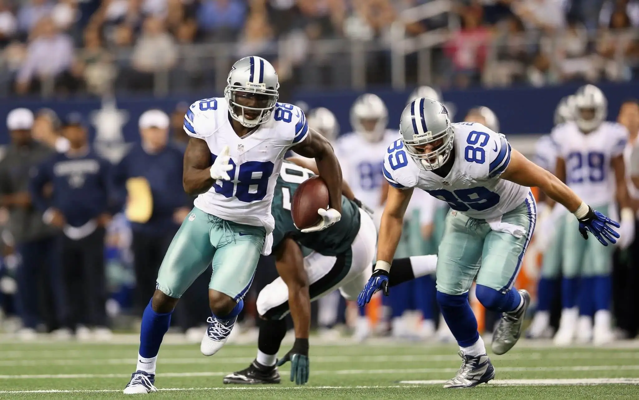 Dallas Cowboys running back Dak Prescott in action during a game, showcasing his athleticism and team spirit on the field.